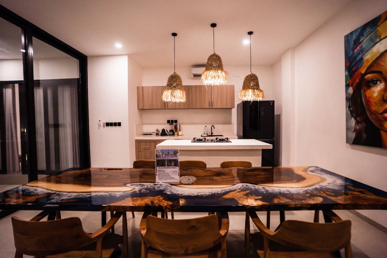 The epoxy river dining table and open kitchen at Villa Amazonica